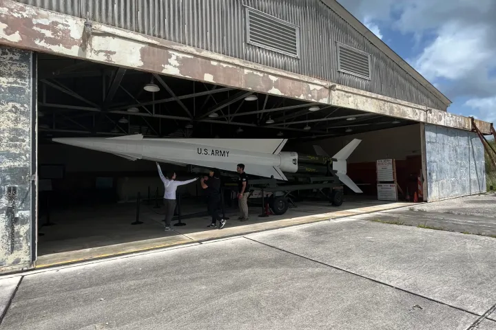 a train is parked on the side of a building