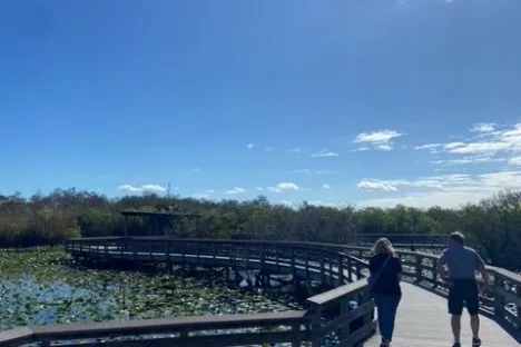 a group of people walking on a bridge