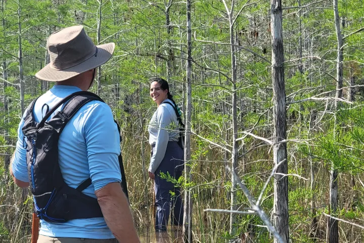 a man standing next to a tree