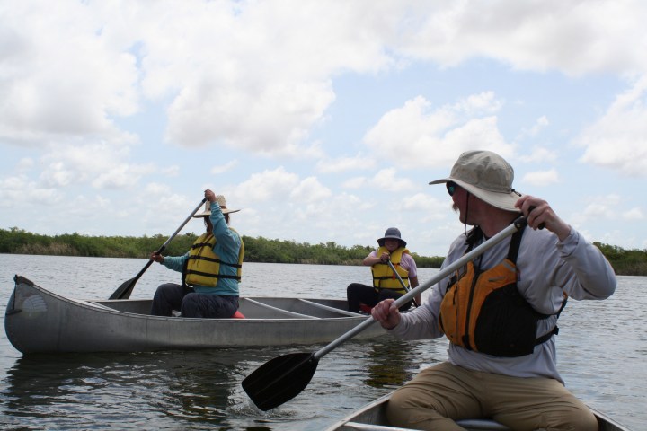 a group of people riding on the back of a boat